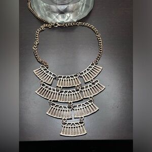 Gold coloured necklace.